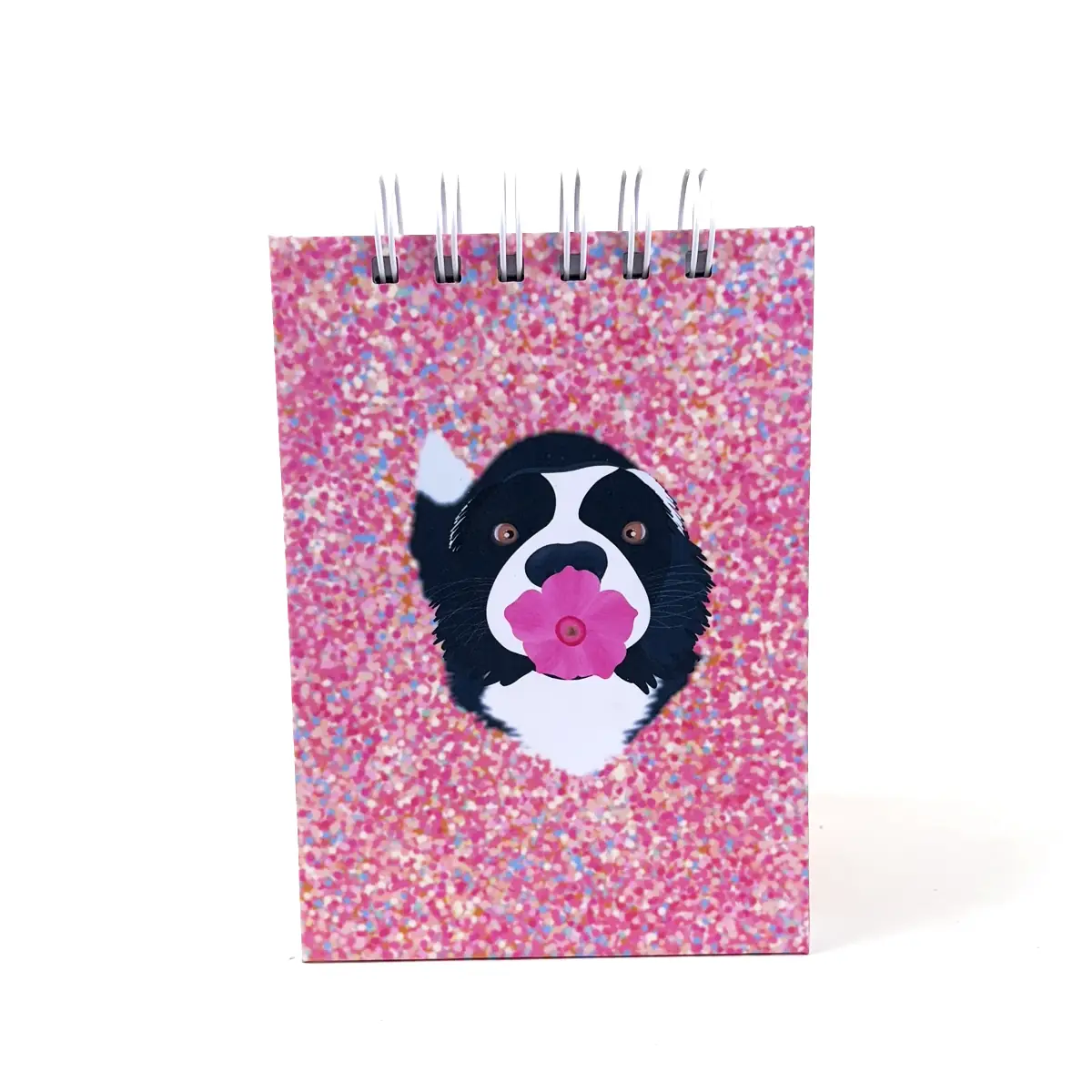 Libreta A6 Bloom rosada con efecto glitter y perrito con flor y anillos superiores