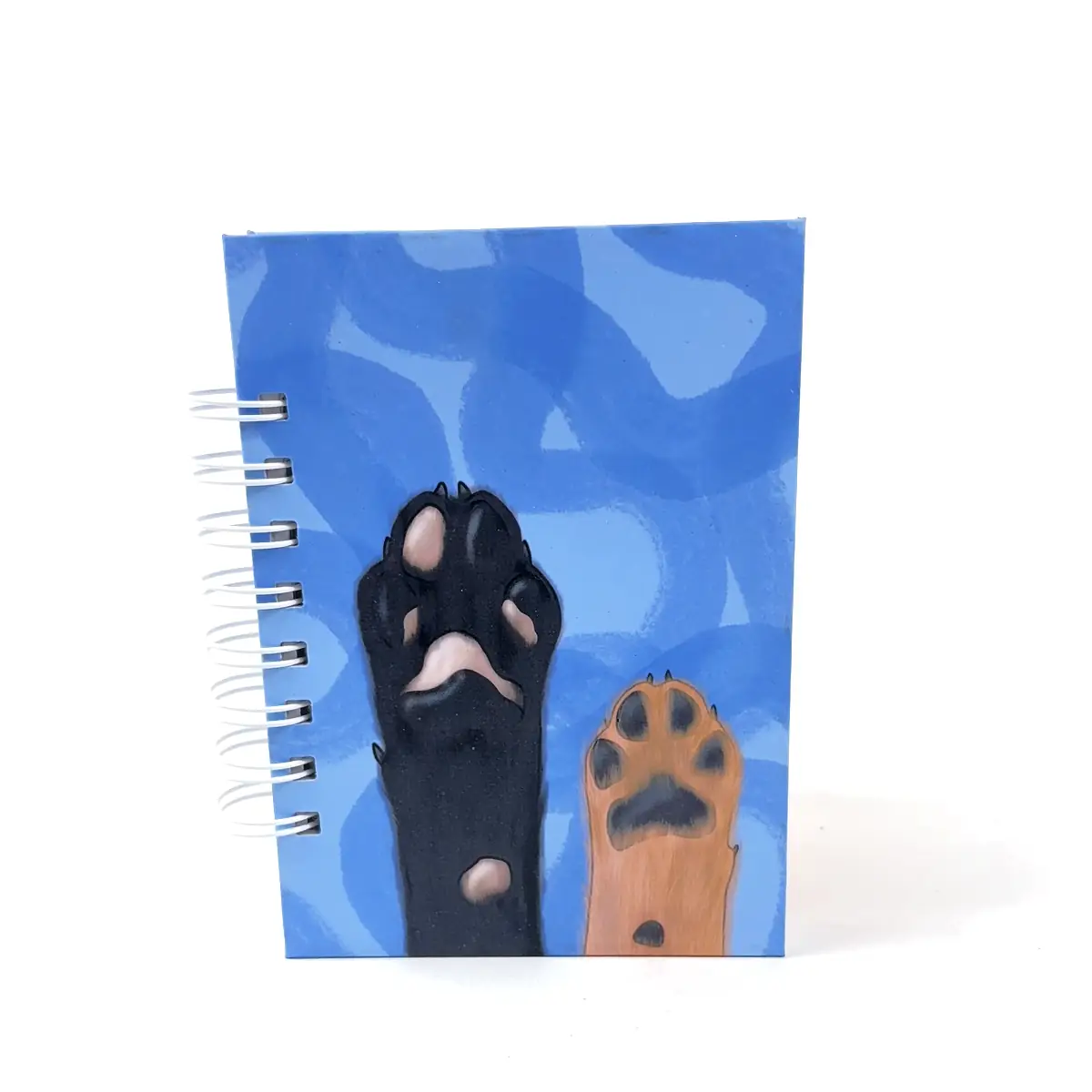 Libreta A6 Paws azul con diseño de patitas y anillos laterales